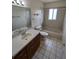 Cozy bathroom features a combination tub and shower, and a single sink vanity at 10315 Sw 62Nd Terrace Rd, Ocala, FL 34476