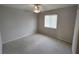 Cozy bedroom featuring neutral carpet and walls, enhanced with a ceiling fan and natural light at 10315 Sw 62Nd Terrace Rd, Ocala, FL 34476