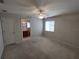 Spacious bedroom boasts neutral walls, plush carpet, ceiling fan, and ensuite bathroom access at 10315 Sw 62Nd Terrace Rd, Ocala, FL 34476
