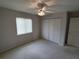 Well-lit bedroom featuring carpet, closet, and window with blinds providing comfort at 10315 Sw 62Nd Terrace Rd, Ocala, FL 34476
