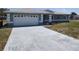 Well kept home with a paved driveway and a two car garage, showcasing curb appeal at 10315 Sw 62Nd Terrace Rd, Ocala, FL 34476