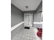 Inviting front porch with tiled flooring, and flower beds, providing a warm welcome at 10315 Sw 62Nd Terrace Rd, Ocala, FL 34476