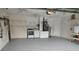 Spacious garage featuring laundry hookups, shelving, and ample storage space for vehicles and belongings at 10315 Sw 62Nd Terrace Rd, Ocala, FL 34476