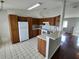 Well-lit kitchen with a breakfast bar and white appliances, offering a functional space for meal preparation at 10315 Sw 62Nd Terrace Rd, Ocala, FL 34476