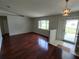 Bright living room featuring hardwood floors, a large window, and a welcoming entrance at 10315 Sw 62Nd Terrace Rd, Ocala, FL 34476