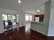 Open-concept living room with hardwood floors, seamlessly connecting to the kitchen for a spacious feel at 10315 Sw 62Nd Terrace Rd, Ocala, FL 34476