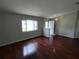 Bright living room featuring hardwood floors, a large window, and a welcoming entrance at 10315 Sw 62Nd Terrace Rd, Ocala, FL 34476