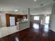 Open-concept living room with hardwood floors, seamlessly connecting to the kitchen for a spacious feel at 10315 Sw 62Nd Terrace Rd, Ocala, FL 34476