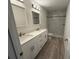 Bathroom featuring dual sinks, granite counters, modern lighting, and a walk-in shower at 11165 Nw 7Th St, Ocala, FL 34482