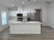 Modern kitchen featuring stainless steel appliances, white cabinetry, and an island with seating at 11165 Nw 7Th St, Ocala, FL 34482