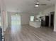 Bright, open-concept living area featuring light floors, a kitchen island, and stainless steel appliances at 11165 Nw 7Th St, Ocala, FL 34482