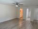 Bright main bedroom featuring sleek floors, ceiling fan, and ensuite bathroom and walk-in closet at 11165 Nw 7Th St, Ocala, FL 34482