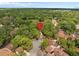 A neighborhood view with mature trees, showing proximity to shopping and dining destinations at 113 Weeping Elm Ln, Longwood, FL 32779