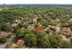 Aerial view of a neighborhood with mature trees, showing proximity to shopping and dining destinations at 113 Weeping Elm Ln, Longwood, FL 32779