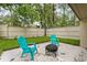 Cozy backyard patio area with a fire pit and colorful Adirondack chairs, perfect for outdoor relaxation at 113 Weeping Elm Ln, Longwood, FL 32779