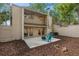The backyard patio has outdoor seating and mature landscaping for private outdoor living and entertaining at 113 Weeping Elm Ln, Longwood, FL 32779