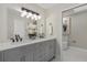 Bathroom with a double vanity with granite countertops, laminated floors and ensuite toilet at 113 Weeping Elm Ln, Longwood, FL 32779