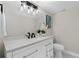 Bathroom featuring a white vanity with granite countertop and decorative lighting at 113 Weeping Elm Ln, Longwood, FL 32779