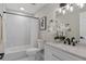 A bathroom featuring a marble tiled shower/tub combo and granite topped vanity at 113 Weeping Elm Ln, Longwood, FL 32779