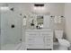 Bright bathroom with glass enclosed shower, vanity with flowers, and a toilet at 113 Weeping Elm Ln, Longwood, FL 32779