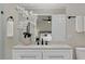 Modern bathroom vanity with granite countertop, black faucet, and decorative flowers at 113 Weeping Elm Ln, Longwood, FL 32779