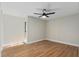 Empty bedroom features wood-look flooring and bright, vertical shiplap walls at 113 Weeping Elm Ln, Longwood, FL 32779