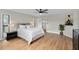 Bedroom with a ceiling fan, ensuite bathroom and laminated floors at 113 Weeping Elm Ln, Longwood, FL 32779