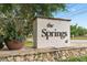 Elegant stone community entrance sign surrounded by lush greenery and landscaping at 113 Weeping Elm Ln, Longwood, FL 32779