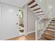 Entryway showcasing a white front door, stairs and wood flooring at 113 Weeping Elm Ln, Longwood, FL 32779