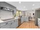 Charming kitchen with stainless steel appliances, tile backsplash, granite countertops, and wood-look flooring at 113 Weeping Elm Ln, Longwood, FL 32779