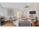 Bright living room with vaulted ceilings, comfortable seating, modern fan, and sliding glass doors to backyard at 113 Weeping Elm Ln, Longwood, FL 32779