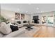 Cozy living room featuring a stone fireplace, plush sofas, and wood floors at 113 Weeping Elm Ln, Longwood, FL 32779