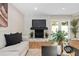 Bright living room boasting a stone fireplace, wood flooring, and ample natural light at 113 Weeping Elm Ln, Longwood, FL 32779
