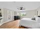 Bright main bedroom featuring wood floors, a ceiling fan, and natural light at 113 Weeping Elm Ln, Longwood, FL 32779