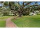 A neighborhood park with mature trees, a walkway, and a playground at 113 Weeping Elm Ln, Longwood, FL 32779