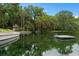 This property has a waterfront dock and gazebo with lush landscaping at 113 Weeping Elm Ln, Longwood, FL 32779