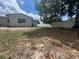 Backyard featuring a privacy fence, a large shade tree and the back of the home at 14646 Sw 43Rd Court Rd, Ocala, FL 34473