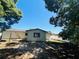 View of the back of the house with trees and partially shaded yard at 14646 Sw 43Rd Court Rd, Ocala, FL 34473