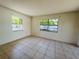 Inviting bedroom with tile flooring, bright walls and two windows at 14646 Sw 43Rd Court Rd, Ocala, FL 34473