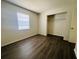 An empty bedroom with hardwood floors, a window and closet at 14646 Sw 43Rd Court Rd, Ocala, FL 34473
