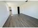 Spacious bedroom with wood-look flooring, access to bathroom and closet, and bright neutral walls at 14646 Sw 43Rd Court Rd, Ocala, FL 34473