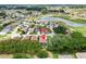 Drone shot of a home in a community with a golf course, lake, and mature trees at 17536 Se 119Th Cir, Summerfield, FL 34491
