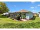 Well-maintained backyard featuring a screened patio and lush landscaping at 17536 Se 119Th Cir, Summerfield, FL 34491