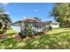 Beautiful backyard with a screened-in patio and manicured lawn at 17536 Se 119Th Cir, Summerfield, FL 34491