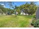 Lush backyard with mature trees and a well-maintained lawn at 17536 Se 119Th Cir, Summerfield, FL 34491