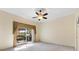 Large bedroom with carpet flooring, a ceiling fan, and sliding glass doors to the lanai at 17536 Se 119Th Cir, Summerfield, FL 34491