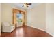 Bright bedroom with hardwood floors, a ceiling fan, and a large window with backyard views at 17536 Se 119Th Cir, Summerfield, FL 34491