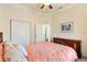 Cozy bedroom with a soft, quilted bedspread and decorative details at 17536 Se 119Th Cir, Summerfield, FL 34491