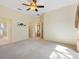 Spacious main bedroom with neutral carpet and access to ensuite bathroom at 17536 Se 119Th Cir, Summerfield, FL 34491