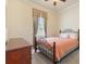 Comfortable bedroom with carpet floors and a window offering natural light at 17536 Se 119Th Cir, Summerfield, FL 34491